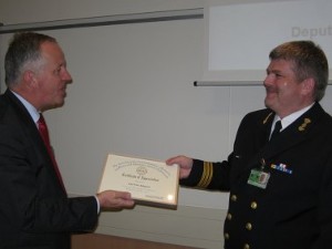 Cmdr. Peter Adegeest, RNLN (r), command, control and communications adviser to the Netherlands military representative, NATO HQ, receives
a certificate of appreciation from Adm. Voogt for his presentation on the NATO Bi-Strategic Command automated information system project at the October meeting.
